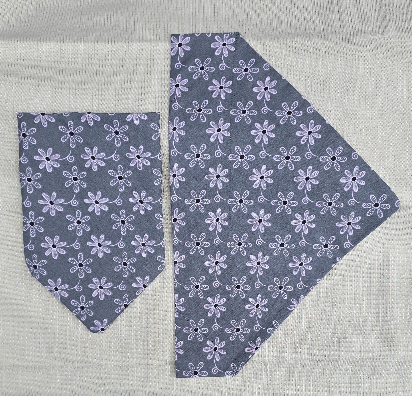 Gray dog bandanas with pink flowers.
