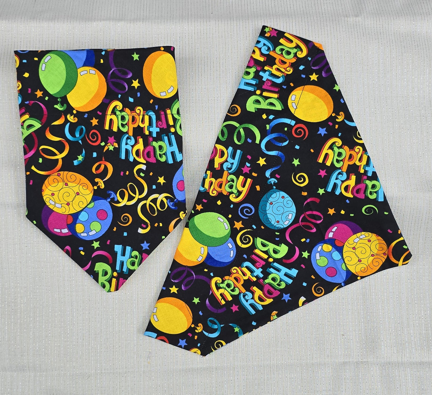 Multiple color birthday bandanas for dogs.