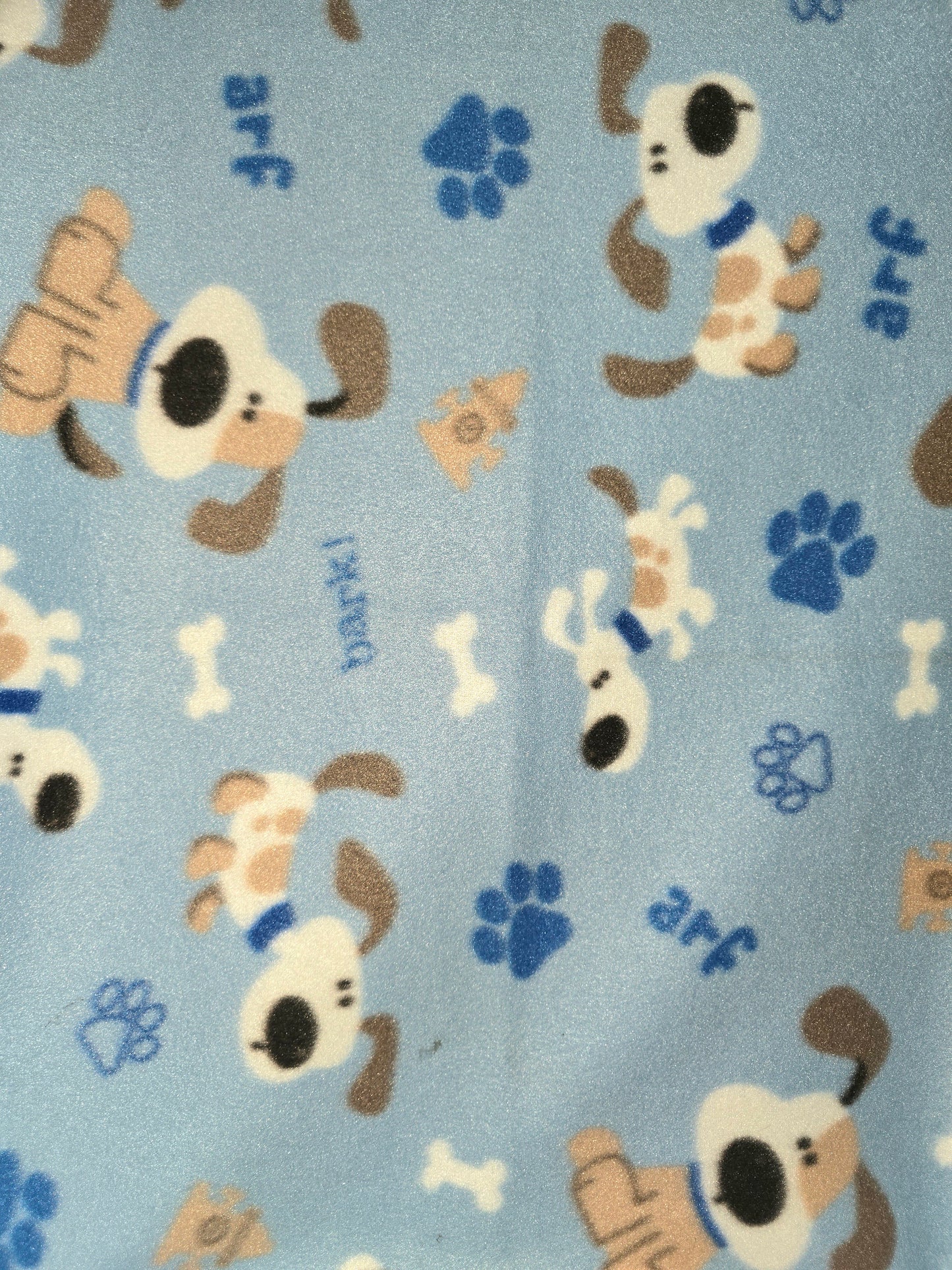 Light blue fleece dog blanket with puppies and paw prints.