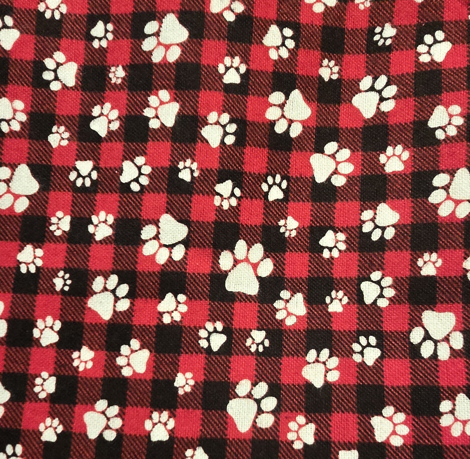 Red and black plaid dog bandana with white paw prints.